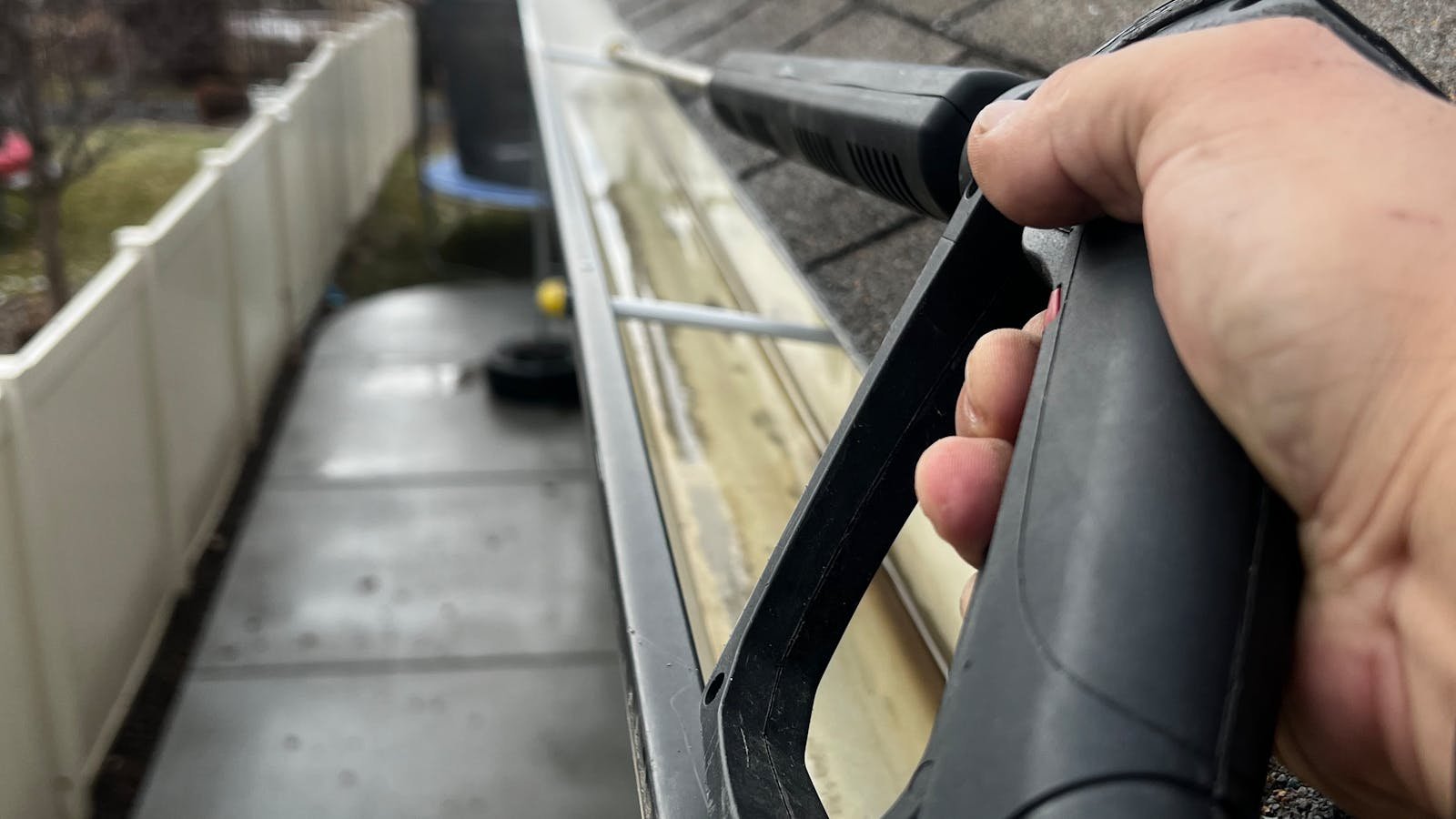 Professional gutter cleaning with pressure washer